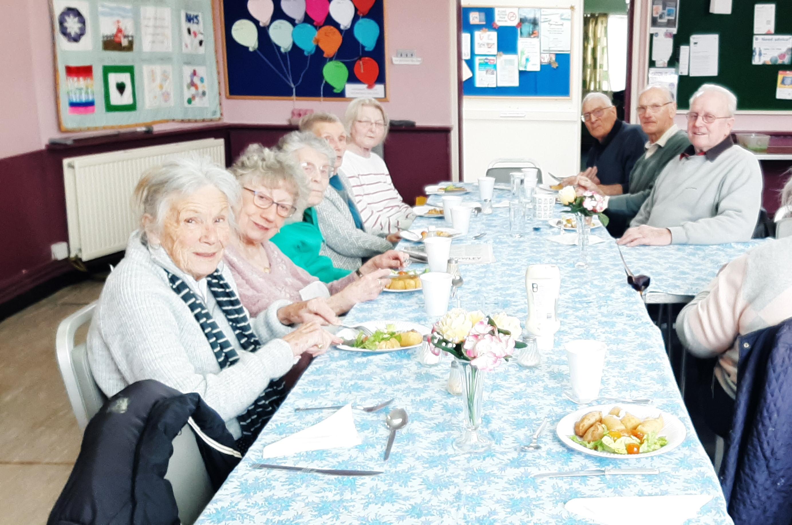 Photo of group sitting down at lunch